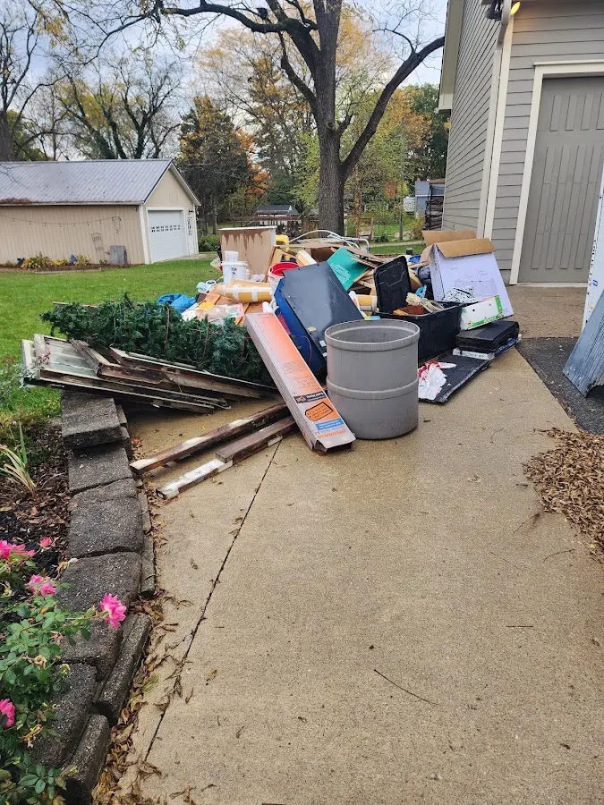 Dumpster being loaded with debris for Demolition Dumpster Rental in Rice Lake